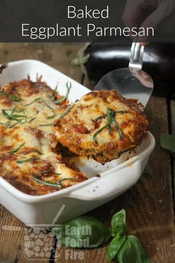 baked eggplant parmesan in a casserole dish on a barn board table