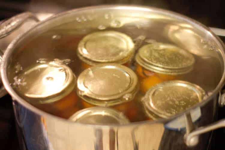 canning pickled cherry tomatoes in a hot water bath