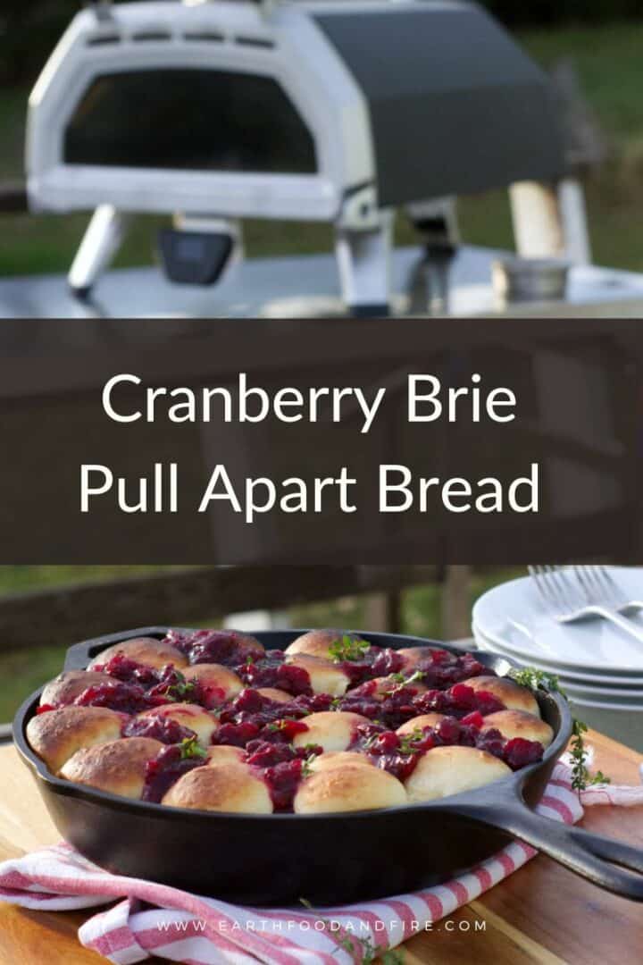 Pinterest pin image of cranberry brie pull apart bread bread served in an outdoor setting.