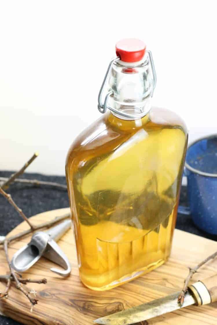 a glass bottle filled with light golden maple syrup