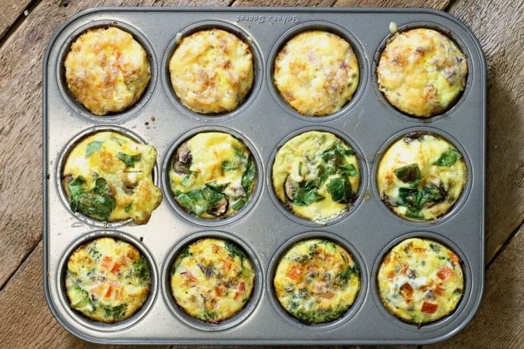 Three different kinds of breakfast egg muffins in a 12 cup muffin tin