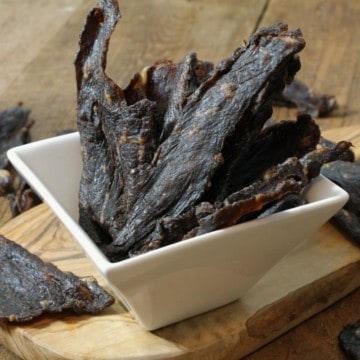 homemade beef jerky on a square white serving bowl