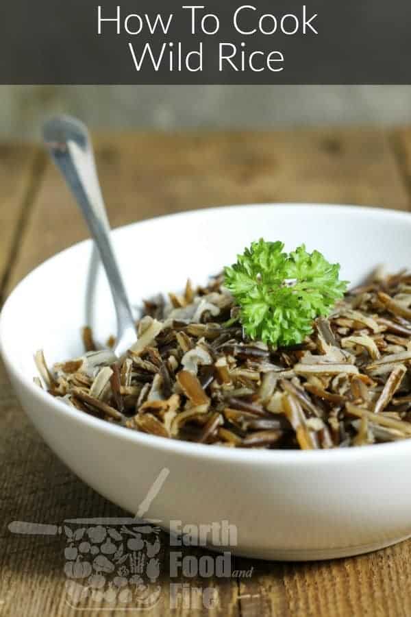 Pinterest pin image of cooked wild rice in a white porcelain bowl garnished with a parsley sprig.