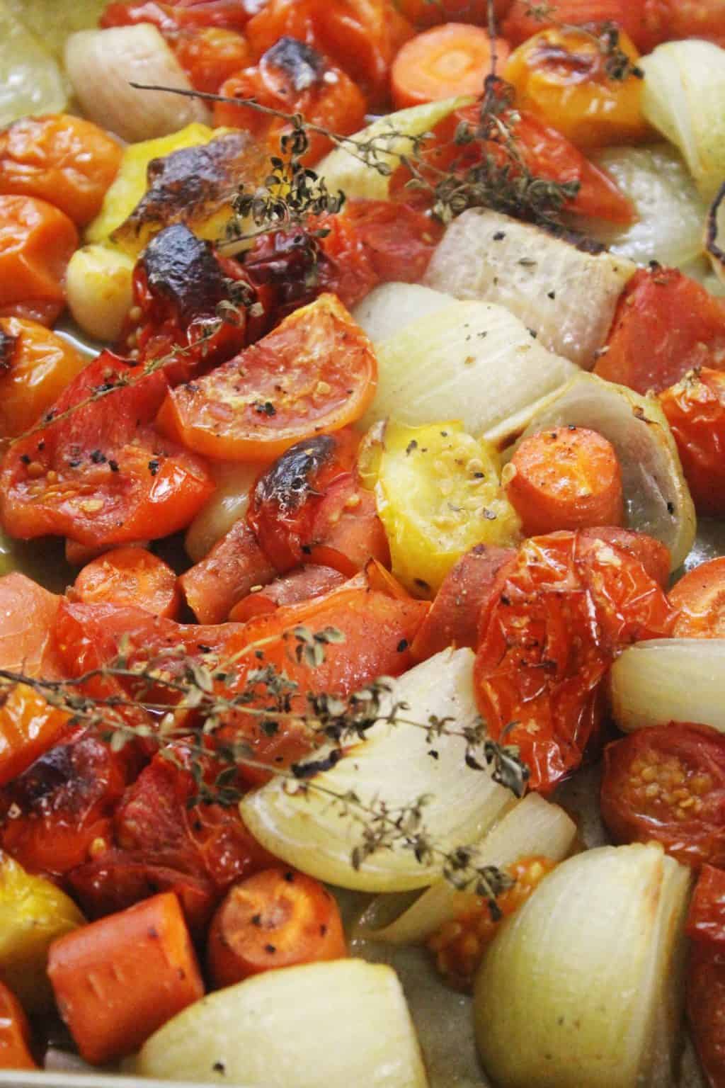oven roasted tomato, onions and herbs on a sheet pan