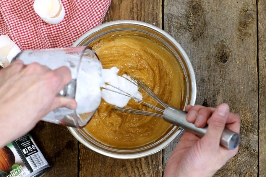 an overhead shot of dairy free pumpkin pie filling being mixed in a stainless steel bowl
