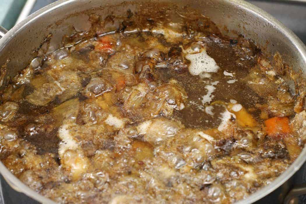 A beef stock simmering away on the stove top