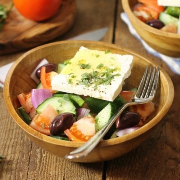 traditional greek salad known in greece as horiatiki, served in a rustic wooden bowl