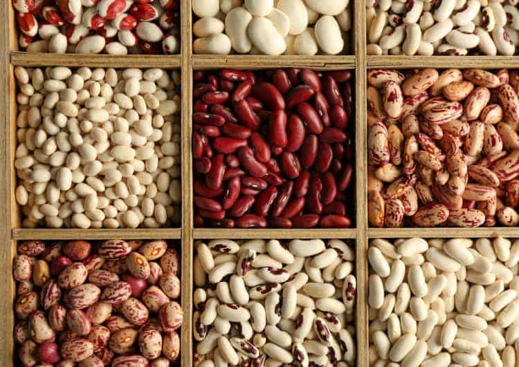 Assortment of beans in wooden box, closeup